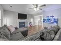 Spacious living room with L-shaped sectional sofa, fireplace and large aquarium at 3000 Trellis Ln, Monroe, NC 28110