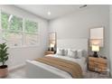 Bright bedroom with neutral decor, double windows, and plush bedding at 3059 Finchborough Ct # 217, Charlotte, NC 28269