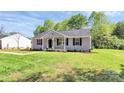 Attractive single-story home showcasing gray siding, black shutters, and a lush green lawn at 3321 15Th Sw Ave, Hickory, NC 28602