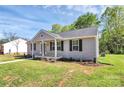 Inviting single-story home with gray siding, black shutters, and a charming front porch at 3321 15Th Sw Ave, Hickory, NC 28602