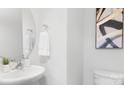 Modern bathroom with a pedestal sink, toilet and decorative art at 5067 Beargrass Dr, Dallas, NC 28034