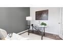 Modern home office with glass desk and gray accent wall at 5067 Beargrass Dr, Dallas, NC 28034
