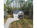 Two-story home featuring a covered front porch and an attached garage, situated on a spacious lot with mature trees at 5528 Brickstone Dr, Charlotte, NC 28227