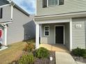 Inviting front entrance with a covered porch and landscaping at 8112 Derby Woods Ln, Charlotte, NC 28214