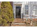 Townhouse entry with brick steps and black door at 9638 Longstone Ln, Charlotte, NC 28277