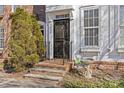 Townhouse entry with brick steps and black door at 9638 Longstone Ln, Charlotte, NC 28277