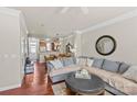 Spacious living room with hardwood floors, large sectional sofa, and view into kitchen at 9638 Longstone Ln, Charlotte, NC 28277