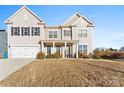 Two-story house with beige siding, a large front yard, and a two-car garage at 10045 Carousel Corral Dr, Midland, NC 28107