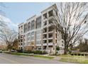 Upscale apartment building showcasing multiple balconies, modern architecture, and professional landscaping at 130 Cherokee Rd # 104, Charlotte, NC 28207