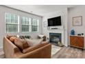 Bright living room with a fireplace, large windows, and comfortable leather sofa at 1342 Galloway Rd # 132, Charlotte, NC 28262