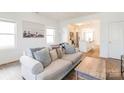 Living room with hardwood floors, sofa and kitchen view at 13871 Clayborn St, Midland, NC 28107