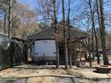 Exterior view of a mobile home with a covered parking area and outdoor seating at 140 Landlubber Trl # H73, Mount Gilead, NC 27306