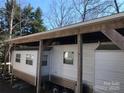 Exterior of a mobile home featuring multiple windows and covered parking area at 140 Landlubber Trl # H73, Mount Gilead, NC 27306