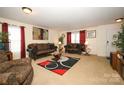 Spacious living room with ample seating and a view into dining area at 185 Altondale Dr, Statesville, NC 28625