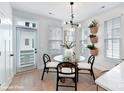 Bright dining area with glass table and modern light fixture at 2327 Rozzelles Ferry Rd # 26, Charlotte, NC 28208