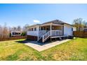 Backyard featuring a fenced-in yard, a covered porch and patio with concrete pavers at 300 Pine Meadows Cir, Hickory, NC 28601