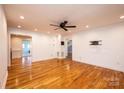 Spacious living room featuring hardwood floors, a ceiling fan, and neutral wall colors at 300 Pine Meadows Cir, Hickory, NC 28601