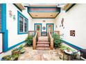 Covered entryway with brick steps, stone patio, and colorful accents creating a cozy outdoor space at 3024 Kern Dr, Salisbury, NC 28147