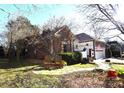 Brick home with stone walkway and mature trees at 3024 Kern Dr, Salisbury, NC 28147