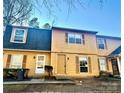 Two-story yellow home with gray roof, two units shown at 3959 Briarhill Dr, Charlotte, NC 28215