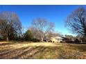 Side view of ranch home showcasing a large backyard at 412 Princeton Dr, Salisbury, NC 28144