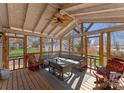 Bright screened in sunroom featuring a ceiling fan, stylish seating and wood floors at 443 Picadilly Ln, Troutman, NC 28166