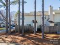 Back of townhome with wooden fence and mature trees in the background at 5702 Prescott Ct, Charlotte, NC 28269