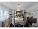 Bright dining room with a round table and four chairs, built-in shelving at 5826 Boxer Dr, Iron Station, NC 28080