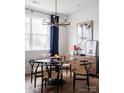 Elegant dining room with a round glass table and mid-century modern chairs at 6027 Pivot Ct, Charlotte, NC 28205