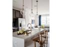 Modern kitchen with a large island, quartz countertops, and stainless steel appliances at 6027 Pivot Ct, Charlotte, NC 28205