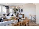 Light-filled dining area features a large wooden table, modern chairs, and stylish decor at 7015 Impulse Ct, Charlotte, NC 28205