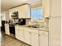 Modern kitchen with white cabinets and stainless steel appliances at 758 Shannon Meadows Rd, Clover, SC 29710