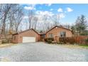 Well-maintained home featuring manicured landscaping and gravel driveway at 8115 Kingsland Dr, Waxhaw, NC 28173