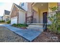 House exterior showcasing a walkway to the front door and landscaping at 900 Raffaelo Vw, Mount Holly, NC 28120