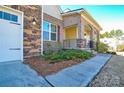 Brick house exterior with a covered porch and landscaped front yard at 900 Raffaelo Vw, Mount Holly, NC 28120