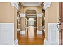 Grand foyer with elegant arches, columns, hardwood floors, and an open view to other living spaces at 103 Glenholden Ln, Mooresville, NC 28115