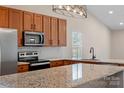 Modern kitchen featuring granite countertops and stainless steel appliances at 109 Washburn Range Dr, Mooresville, NC 28115