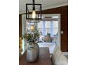 Bright dining room with a wooden table and sunroom view at 11270 Widenhouse Rd, Midland, NC 28107