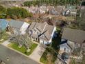 Aerial view showcasing a two-story house, driveway, and neighborhood at 114 Runningdeer Dr, Mooresville, NC 28117