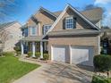 Two-story house with a double garage and well-manicured lawn at 114 Runningdeer Dr, Mooresville, NC 28117