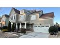 Two-story house with gray siding, white columns, and a two-car garage at 11519 Sweet Birch Ln, Charlotte, NC 28278