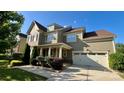 Beautiful home showcasing a well-kept lawn, attached two-car garage, and welcoming front porch at 11519 Sweet Birch Ln, Charlotte, NC 28278