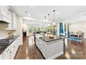 Bright, open kitchen with a large island, stainless appliances, and hardwood floors at 11519 Sweet Birch Ln, Charlotte, NC 28278