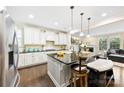 Spacious kitchen featuring white cabinets, granite countertops, and an island at 11519 Sweet Birch Ln, Charlotte, NC 28278