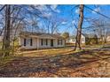 Front view of a charming house with a yard and mature trees at 116 Westover Ave, Kannapolis, NC 28081