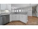 White kitchen with granite countertops and stainless steel dishwasher at 11615 Kingsley View Dr, Charlotte, NC 28277