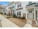 Townhome exterior showcasing gray and white siding, a stone foundation, and landscaping at 12515 Bryton Ridge Pkwy, Huntersville, NC 28078