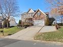 Brick two-story house with a long driveway and landscaping at 12835 Cadgwith Cove Dr, Huntersville, NC 28078