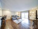 Spacious living room featuring hardwood floors, comfy seating, and large windows at 1323 Queens Rd # 407, Charlotte, NC 28207