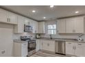 Modern kitchen with white cabinets, granite counters, and stainless steel appliances at 1460 23Rd Sw St, Hickory, NC 28602